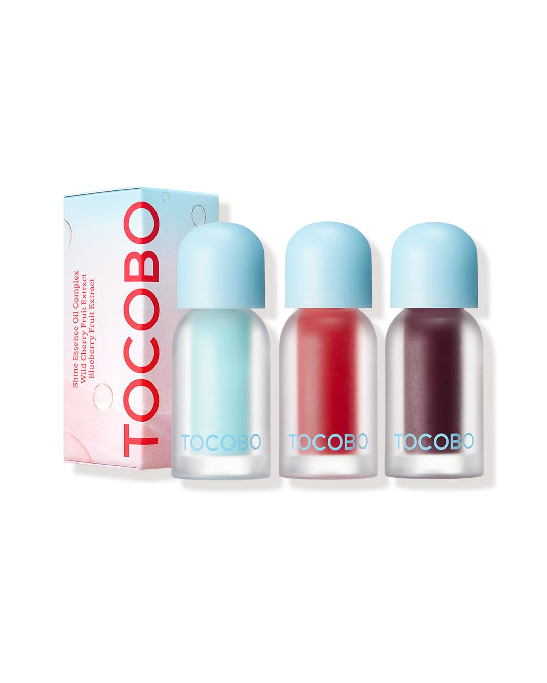 Caja y tres frascos de TOCOBO Juicy Berry Plumping Lip Oil en distintos tonos